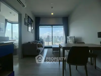 Modern living room with city view and balcony access in high-rise apartment