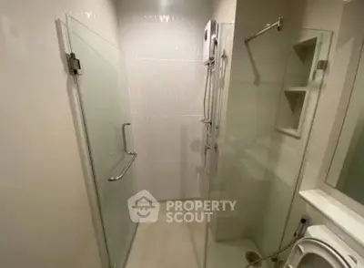 Modern bathroom with glass shower enclosure and sleek fixtures