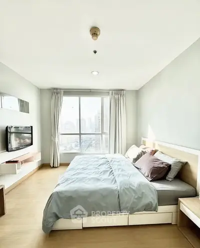 Bright and spacious bedroom with city view, modern furnishings, and natural light.