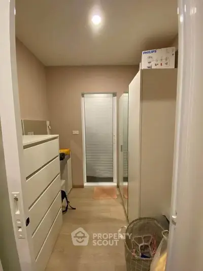 Compact storage room with modern cabinets and natural lighting