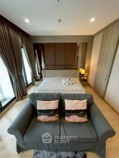 Luxurious bedroom with stylish decor and cozy seating area, perfect for relaxation.