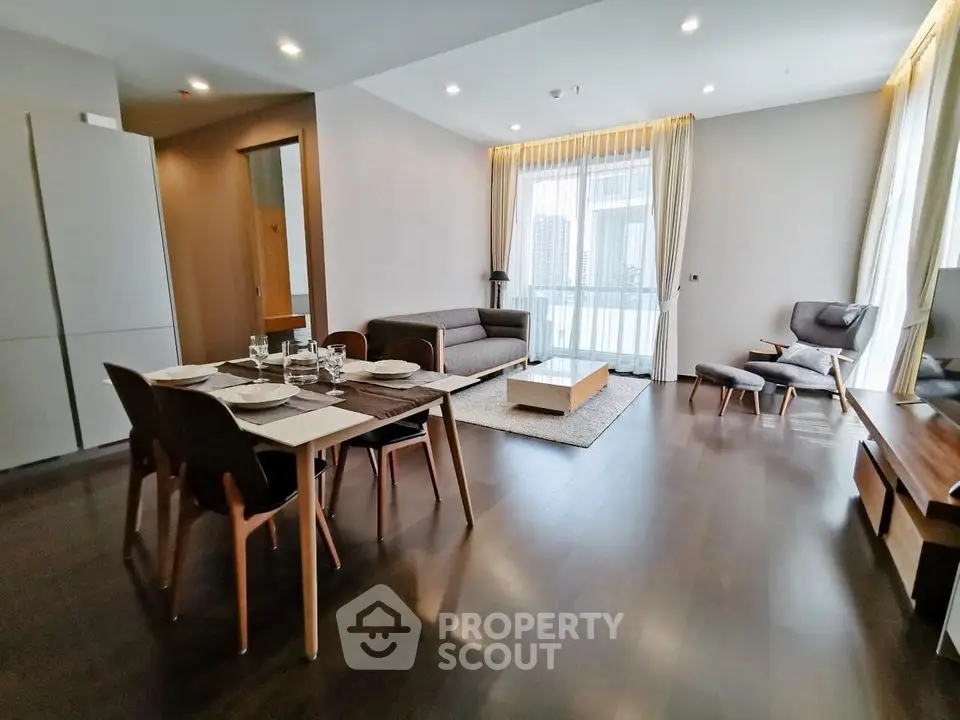 Spacious modern living room with elegant dining area and large windows.