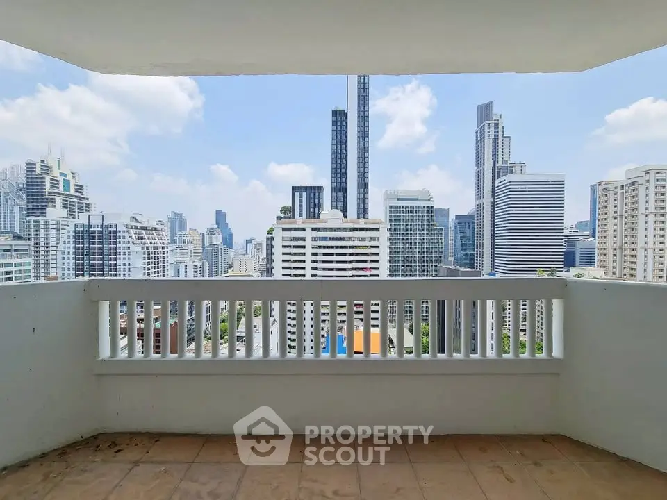 Stunning cityscape view from a spacious balcony in a high-rise apartment.
