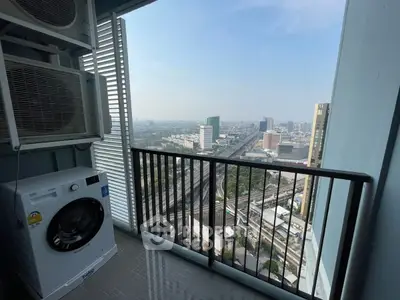 High-rise balcony with city view and washing machine, perfect for urban living.