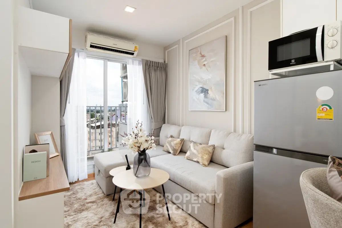 Modern living room with stylish decor, cozy sofa, and large window offering natural light and city views.