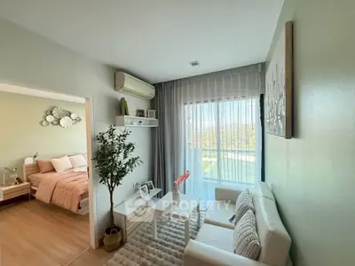 Charming living room with cozy decor and natural light, adjacent to a stylish bedroom.