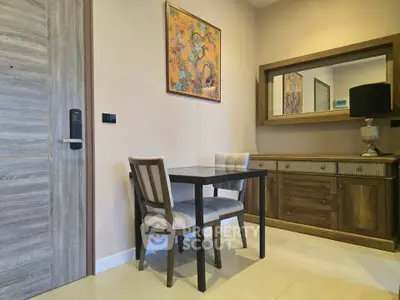 Charming dining nook with elegant wooden furniture and artistic wall decor in a cozy apartment.