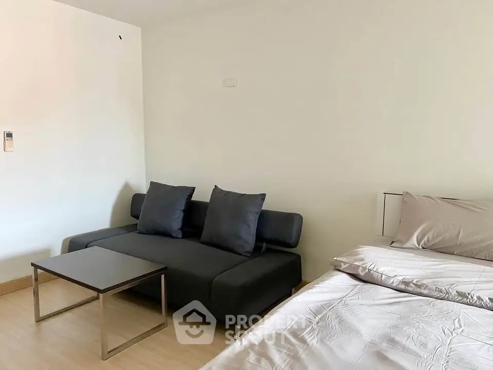 Modern bedroom with sleek sofa and minimalist decor