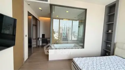Modern bedroom with glass-enclosed bathtub and city view, featuring sleek design and ample natural light.