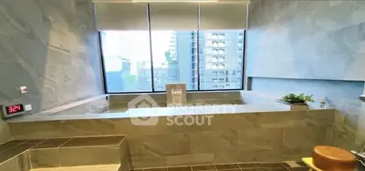 Luxurious bathroom with city view and modern stone bathtub