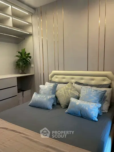 Elegant bedroom with modern decor and plush pillows, showcasing a serene and inviting atmosphere.