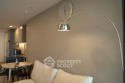 Modern living room with stylish floor lamp and cozy beige sofa