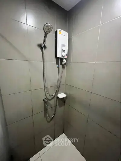 Modern bathroom shower with sleek tiles and water heater
