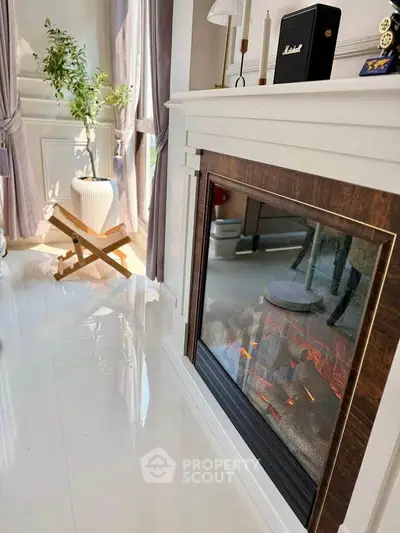 Elegant living room with modern fireplace and stylish decor, perfect for cozy evenings.