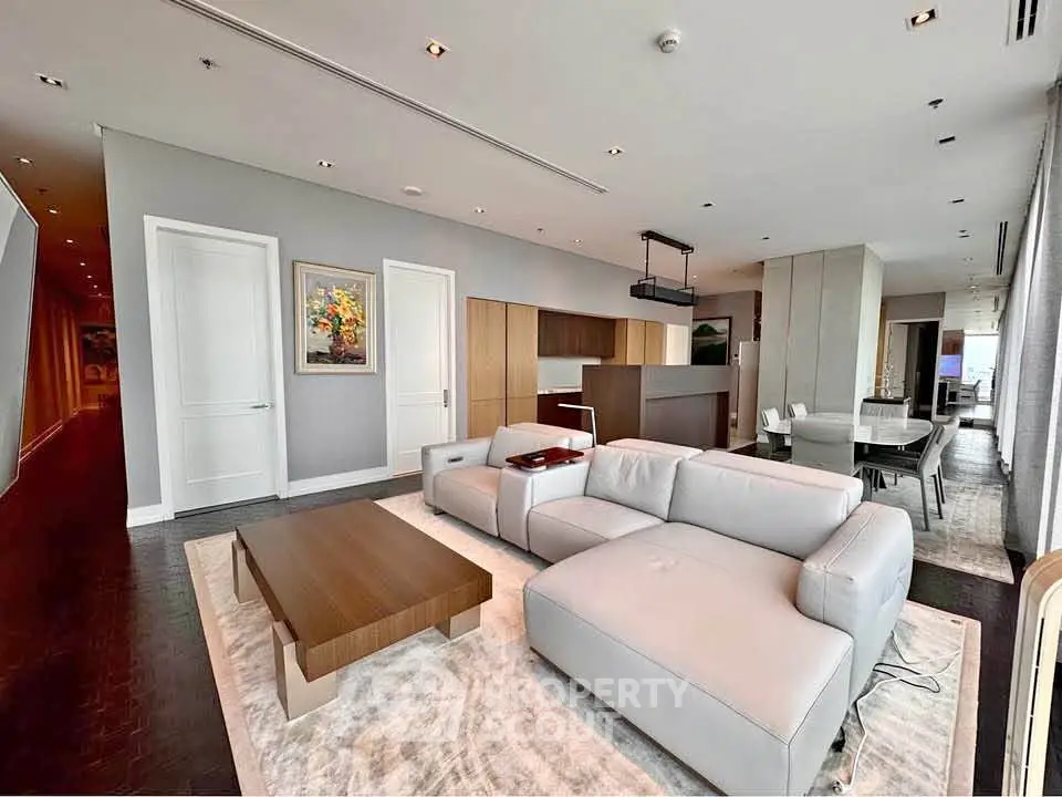 Luxurious open-plan living room with modern furniture and elegant decor in a high-end apartment.