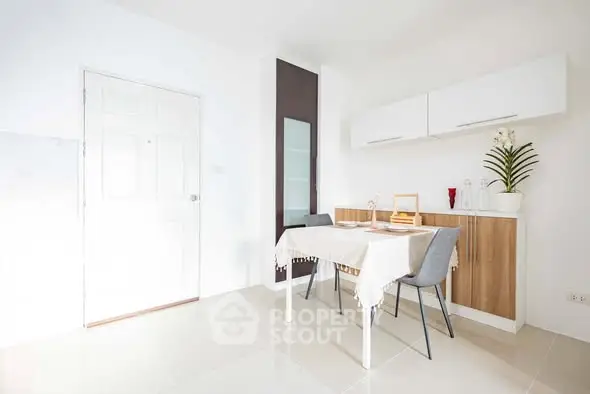 Bright and modern dining area with sleek furniture and minimalist design.