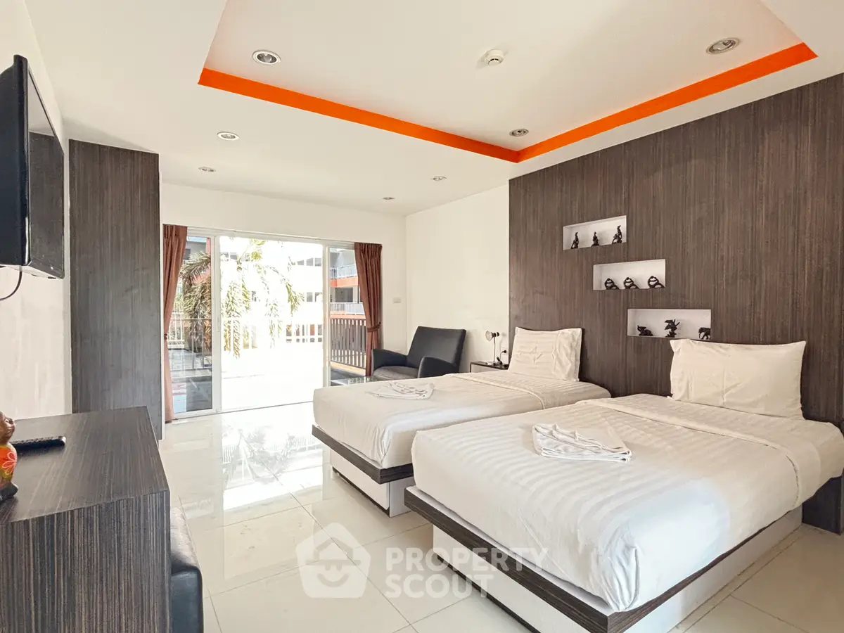 Modern twin bedroom with balcony and stylish decor in a bright apartment