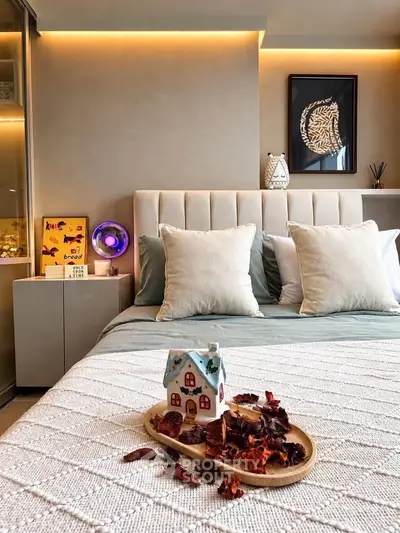 Cozy bedroom with stylish decor and ambient lighting, featuring a plush bed and decorative accents.