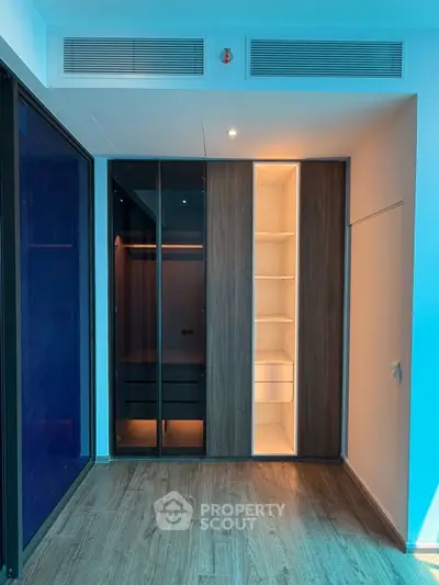 Modern interior with sleek built-in wardrobe and wooden flooring