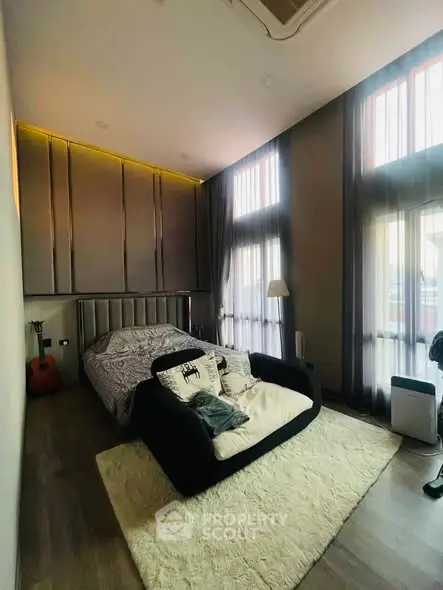 Luxurious bedroom with high ceilings and modern decor