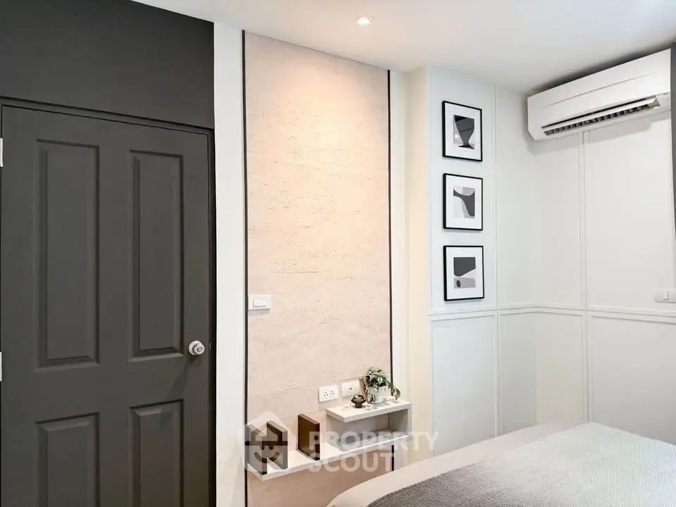 Modern bedroom with stylish decor and air conditioning unit