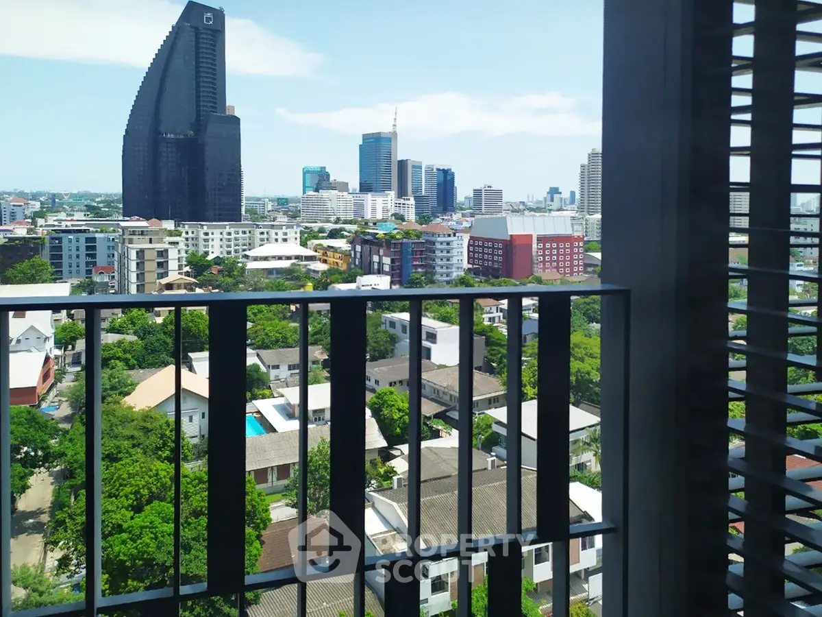 Stunning cityscape view from a high-rise balcony with lush greenery and modern architecture.