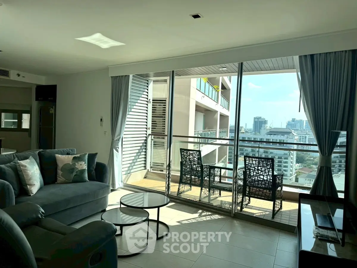 Spacious living room with balcony and city view in modern apartment
