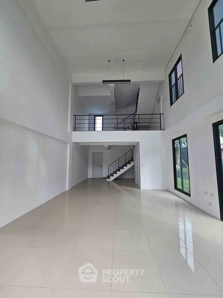 Spacious modern loft with high ceilings and large windows, perfect for urban living.