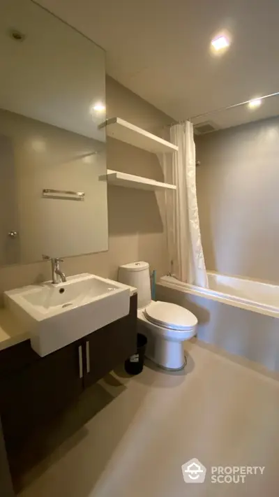 Modern bathroom with sleek fixtures and bathtub in contemporary apartment