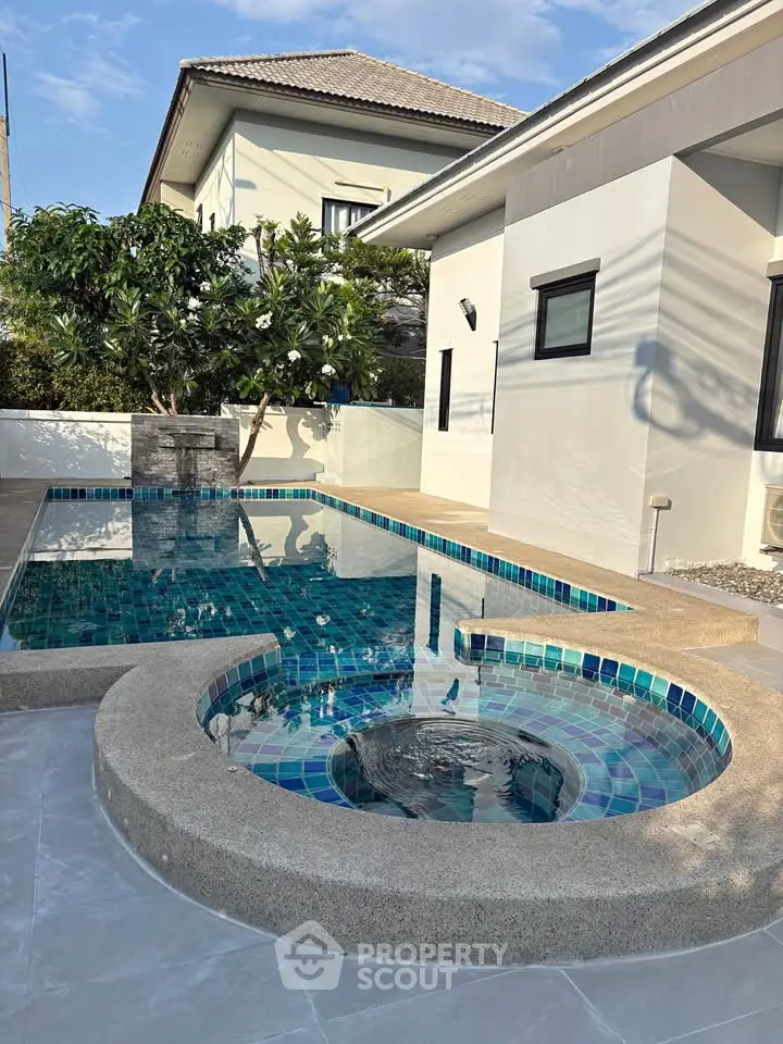 Luxurious private pool and jacuzzi in modern villa with elegant design and serene ambiance.