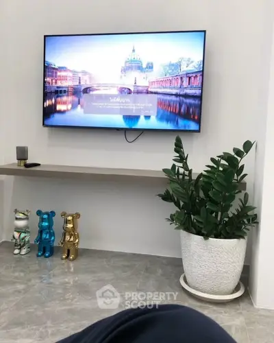 Modern living room with wall-mounted TV and stylish decor
