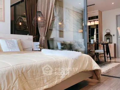 Luxurious bedroom with modern decor and open layout leading to stylish dining area.