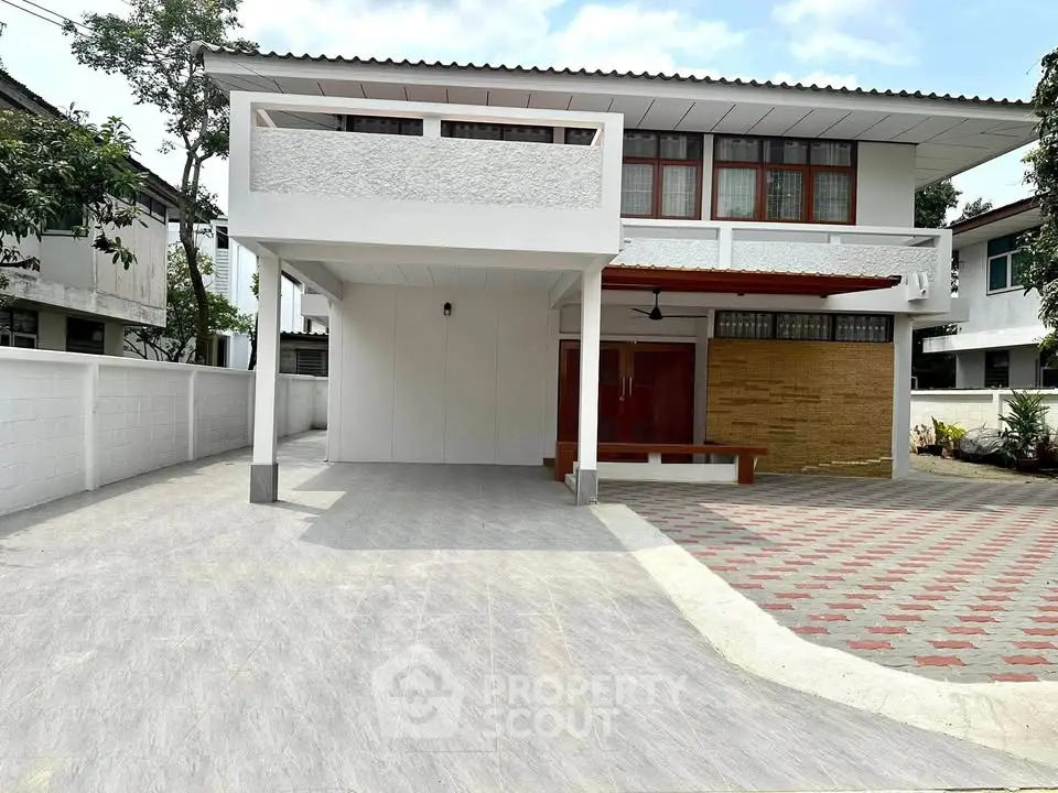 Spacious modern two-story house with large driveway and contemporary design.