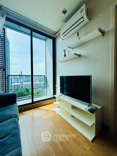 Modern living room with balcony view and sleek air conditioning unit