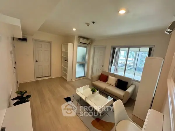 Modern living room with cozy sofa and city view, perfect for urban living.