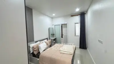 Modern bedroom with neutral tones and sleek design, featuring a comfortable bed and stylish decor.