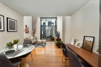 Modern living room with city view, stylish decor, and open layout in a high-rise apartment.
