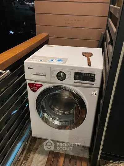 Compact balcony with modern washing machine and wooden railing