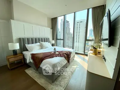 Luxurious bedroom with floor-to-ceiling windows offering stunning city views.