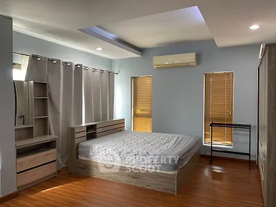 Spacious bedroom with modern wooden furniture and natural light