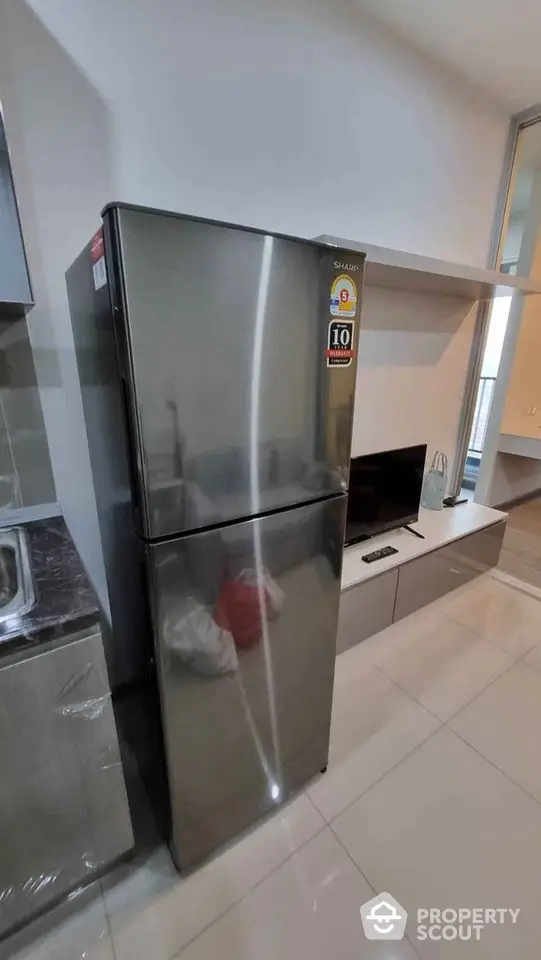 Modern kitchen with stainless steel fridge and sleek cabinetry