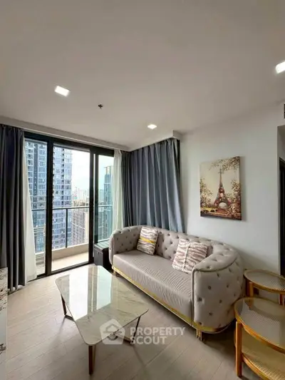 Modern living room with city view and elegant decor in high-rise apartment.