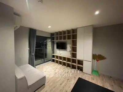 Modern living room with built-in shelving and balcony access