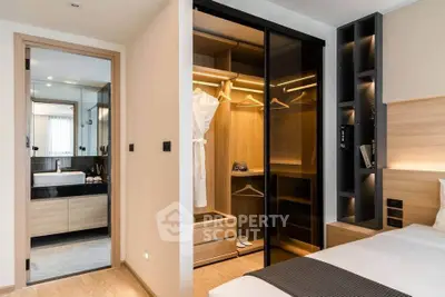 Luxurious bedroom with walk-in closet and modern bathroom in a stylish apartment.