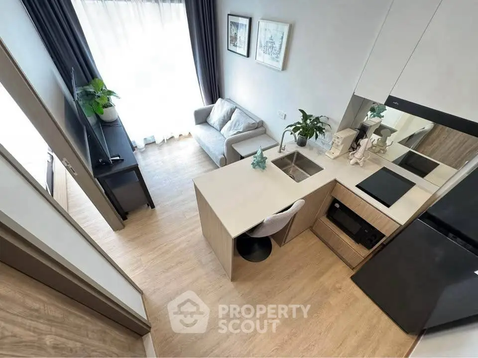 Modern compact living room with open kitchen and stylish decor