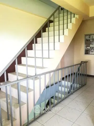 Spacious stairwell with modern railing in a residential building