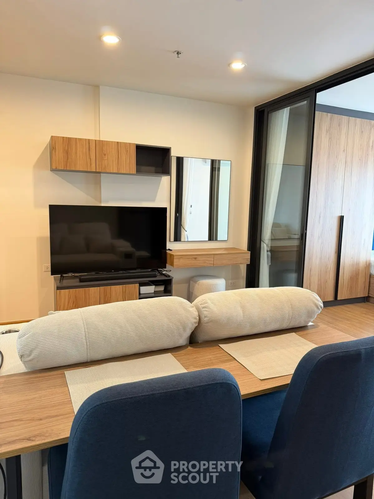 Modern living room with stylish wooden furniture and sleek TV setup