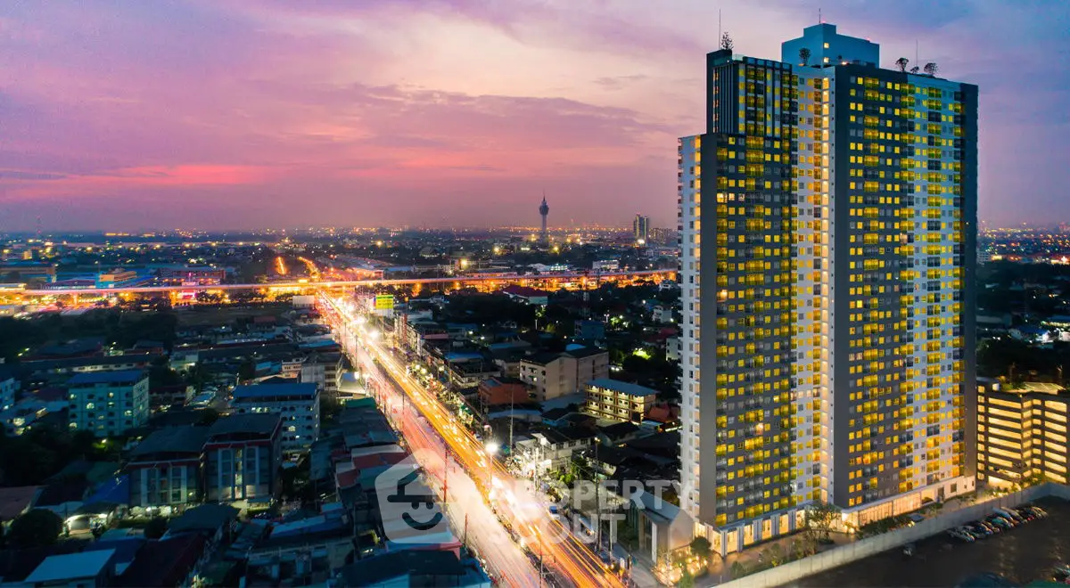 Stunning cityscape view with illuminated high-rise building at dusk, showcasing urban living.