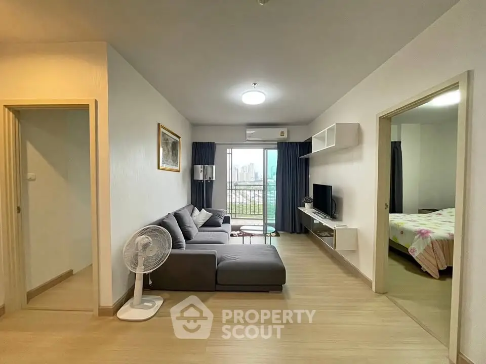 Modern living room with city view, cozy sofa, and stylish decor