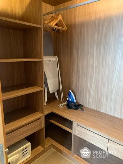 Spacious walk-in closet with wooden shelving and modern design